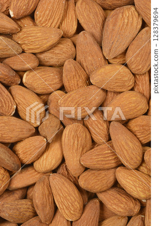 Pile of raw almonds Pile of raw almonds 128379694
