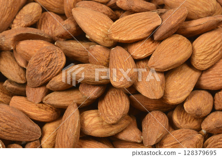 Pile of raw almonds 128379695