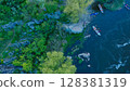 Aerial view of rowers on kayaks docking to the shore. Kayaks heading to the shore after the competition on a turbulent mountain river. 128381319