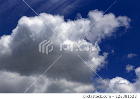 Summer blue sky and floating cumulonimbus clouds Summer blue sky and floating cumulonimbus clouds 128381528