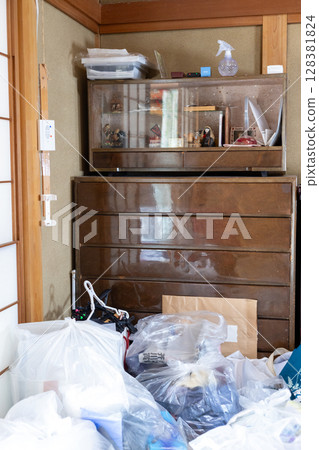 A room full of unnecessary items and trash while packing up my parents' house A room full of unnecessary items and trash while packing up my parents' house 128381824