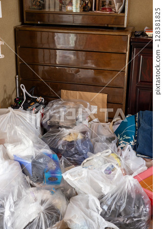 A room full of unnecessary items and trash while packing up my parents' house 128381825