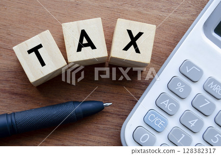 TAX Wooden Cubes and Calculator Representing Finance Concept. 128382317