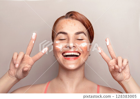 Happy caucasian woman face with pigmentation, melasma, freckles, age spots photo. Woman uses facial care cream Happy caucasian woman face with pigmentation, melasma, freckles, age spots photo. Woman uses facial care cream 128383005