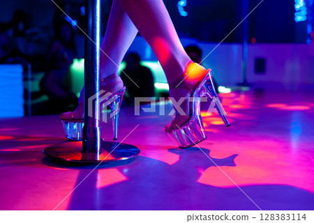 Experience an Electrifying Nightlife Scene Featuring Glamorous High Heels and a Striptease Dance Pole 128383114