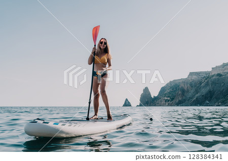Woman Paddleboarding Ocean Coastline Summer Adventure 128384341
