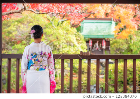 lady in Kimono view shrine and autumn colors in Shinnyodo, Kyoto 128384370