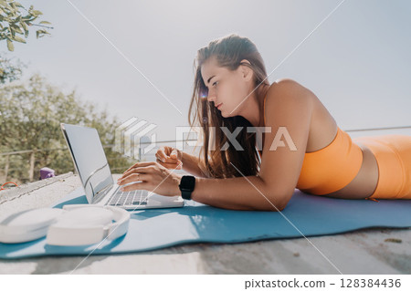 Woman Working on Laptop Outdoors Woman Working on Laptop Outdoors 128384436