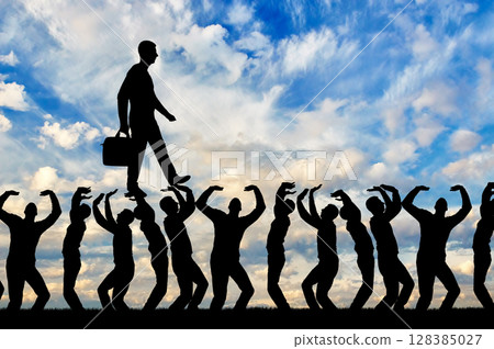 Silhouette of a walking selfish and narcissistic man on the hands of the crowd Silhouette of a walking selfish and narcissistic man on the hands of the crowd 128385027