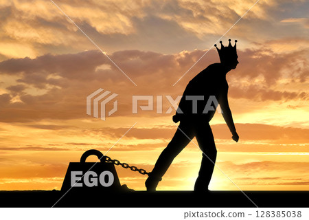 A big weight in the form of an ego is chained to the foot of a selfish and narcissistic man with a crown on his head A big weight in the form of an ego is chained to the foot of a selfish and narcissistic man with a crown on his head 128385038