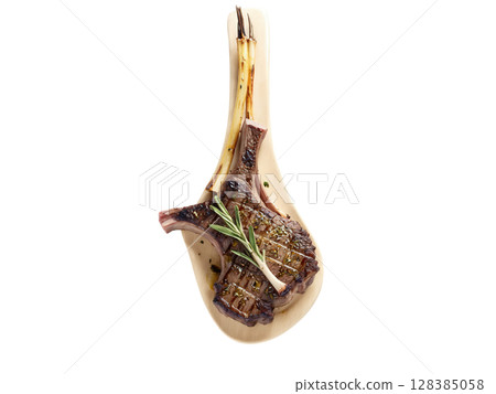 Grilled Lamb Chops Lamb chops seasoned with rosemary, garlic, and lemon zest, then grilled to medium-rare perfection. The meat is 128385058