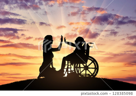 Happy disabled child girl in wheelchair and her mom on a walk 128385098