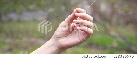 Hand holding a small mustard seed 128386570