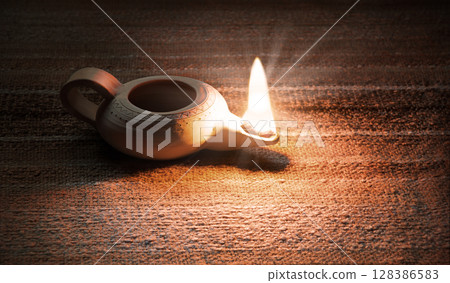 Ancient lamp shines in the dark 128386583