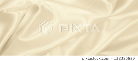 Smooth elegant golden silk or satin luxury cloth texture as wedding background. Luxurious Christmas background or New Year background design. In Sepia toned. Retro style Smooth elegant golden silk or satin luxury cloth texture as wedding background. Luxurious Christmas background or New Year background design. In Sepia toned. Retro style 128386689