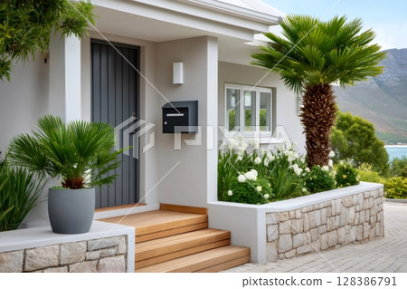Modern house entrance with mediterranean plants and sea view 128386791