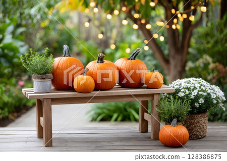 Pumpkins and plants decorating a wooden bench in a garden during autumn 128386875