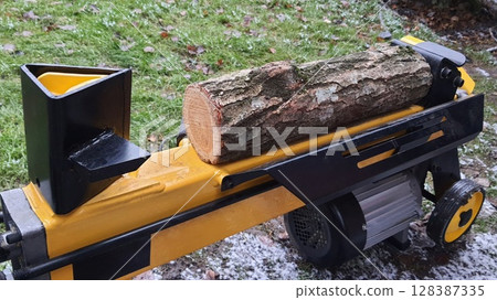 Log Splitter Machine Preparing to Split Firewood Outdoors Log Splitter Machine Preparing to Split Firewood Outdoors 128387335