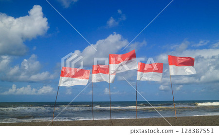 Summer holiday concept. Indonesian flag on the beach with blue sky. 17 August independence day. 128387551