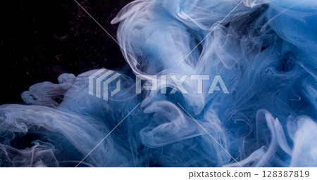 Wave particles. Paint water. Defocused blue purple color swirling glitter liquid fume flowing on abstract dark black art background. Wave particles. Paint water. Defocused blue purple color swirling glitter liquid fume flowing on abstract dark black art background. 128387819