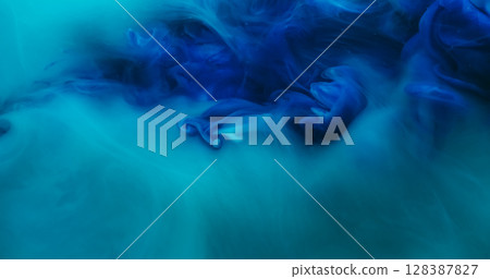 Blend flow. Atmospheric smoke. Defocused blue color ink in water fume swirling fog pigment spreading on abstract acrylic background. 128387827
