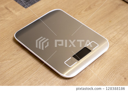 Small electronic scale on the kitchen counter 128388186