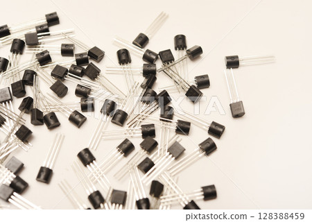 A scattering of plastic transistors. A bipolar transistor for electronics. A scattering of plastic transistors. A bipolar transistor for electronics. 128388459
