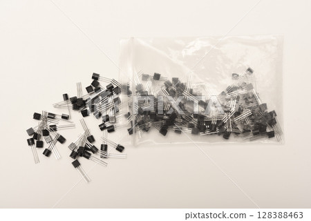 A scattering of plastic transistors. A bipolar transistor for electronics. A scattering of plastic transistors. A bipolar transistor for electronics. 128388463