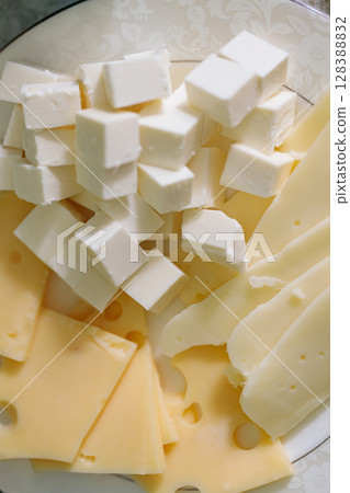 White Feta Cheese Cubes with Yellow Cheese Slices on Plate White Feta Cheese Cubes with Yellow Cheese Slices on Plate 128388832