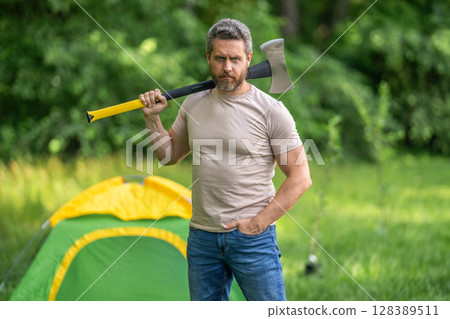 Lumberjack on outdoor camping. Brutal lumberjack. Brutality and masculinity. Hispanic lumberjack man with axe. Lumberjack axe. Man with logging axe. Masculine brutal man 128389511
