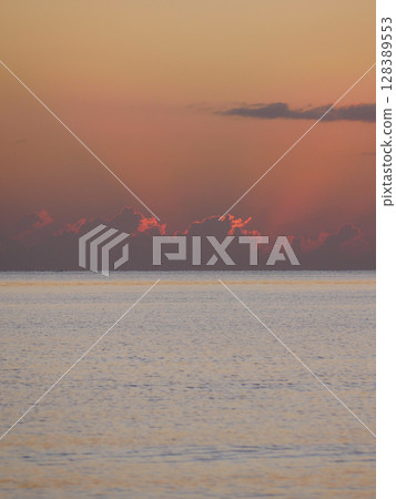 Vivid sunrise over the sea. Peaceful and captivating atmosphere. Nature background, relaxation concept, travel theme and inspirational visual 128389553