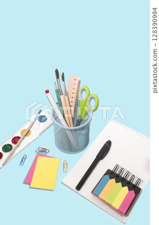 School and office supplies, pens, pencils, ruler, compass, calculator on a blue background. School and office supplies, pens, pencils, ruler, compass, calculator on a blue background. 128390994