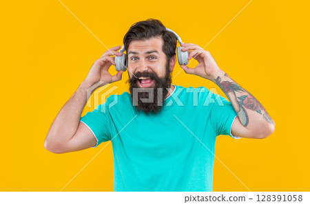 listening to music. modern device of glad guy. hipster guy listening music in earphones listening to music. modern device of glad guy. hipster guy listening music in earphones 128391058