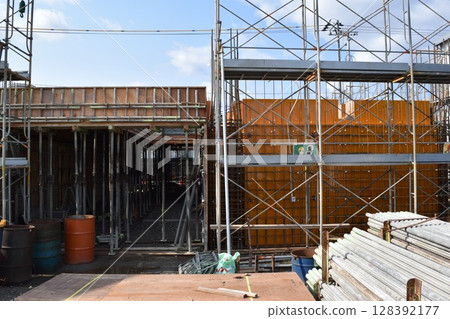 Scaffolding installed at construction site 128392177