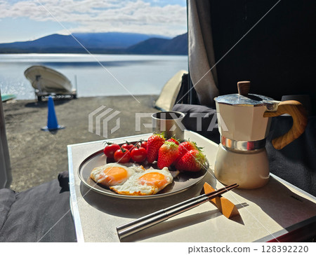 Landscape photography from tent with breakfast food, strewberry, egg, tomato, coffee Landscape photography from tent with breakfast food, strewberry, egg, tomato, coffee 128392220
