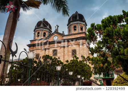 Our Lady of the Immaculate Conception Church and the Jose Maria Cordova Park in the beautiful colonial town of Concepcion in Antioquia, Colombia. 128392499