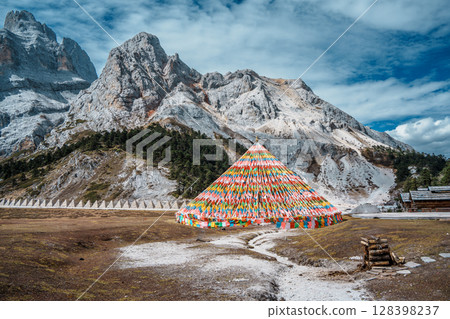 Colorful Tibetan Prayer Flags near Shambhala Pagoda in Balagezong with Snow Mountain Background 128398237