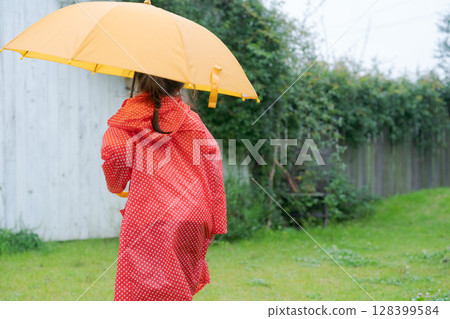 Girls playing in the rain 128399584