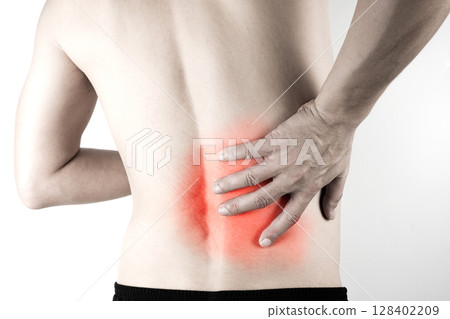 A man presses his hand against his back, has back pain and bone pain. A man presses his hand against his back, has back pain and bone pain. 128402209