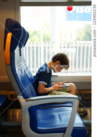 Child Engaged with Tablet on Train Journey Child Engaged with Tablet on Train Journey 128402236