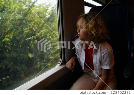 Child Gazing Out Train Window Capturing Serenity 128402281