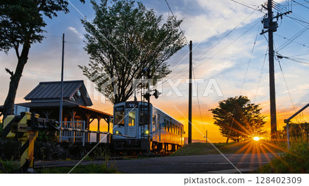 A scene of a station and a train shining in the light of the sunset (Miharashidai Station) (Minamiaso Village) 128402309