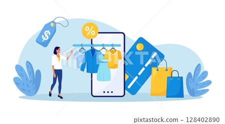 Young woman shopping online using smartphone. Customer choosing modern apparel, wearing, accessories for wardrobe. Clothes hanging on railing hangers with tags. Sale. Internet garment shop Young woman shopping online using smartphone. Customer choosing modern apparel, wearing, accessories for wardrobe. Clothes hanging on railing hangers with tags. Sale. Internet garment shop 128402890