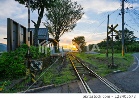 Sunset spot (Miharashidai Station) A sunset train scene set against the rural landscape (Minamiaso Village) 128403578