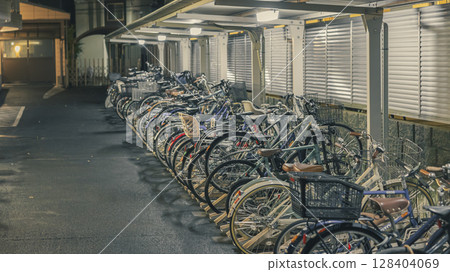 Nighttime, apartment complex, bicycle parking lot, bicycles lined up Nighttime, apartment complex, bicycle parking lot, bicycles lined up 128404069