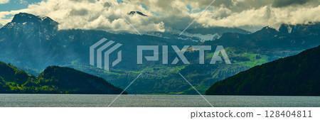 Majestic mountain landscape with clear lake and dramatic clouds in Switzerland during daytime Majestic mountain landscape with clear lake and dramatic clouds in Switzerland during daytime 128404811