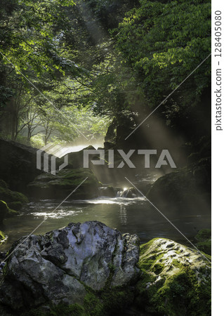 A fantastic mountain stream landscape of the Maruhara River, covered in fresh greenery and moss as the morning sun shines through A fantastic mountain stream landscape of the Maruhara River, covered in fresh greenery and moss as the morning sun shines through 128405080
