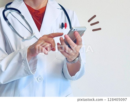Female doctor contacting via smartphone Female doctor contacting via smartphone 128405097
