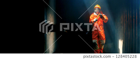 Firefighter Rescue training in fire fighting extinguisher. Firefighter fighting with flame using fire hose chemical water foam spray engine. Fireman wear hard hat, safety suit uniform for protection Firefighter Rescue training in fire fighting extinguisher. Firefighter fighting with flame using fire hose chemical water foam spray engine. Fireman wear hard hat, safety suit uniform for protection 128405228