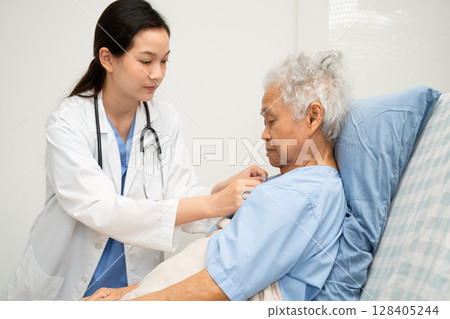 Asian doctor checking and treat elderly woman patient health in hospital. Asian doctor checking and treat elderly woman patient health in hospital. 128405244